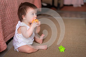 lifestyle home portrait of adorable and beautiful Asian Caucasian mixed baby girl playing on the floor with color blocks excited