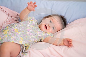 lifestyle home portrait of happy and adorable 9 months old mixed ethnicity Asian Caucasian baby girl playing cheerful and carefree