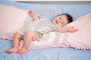 lifestyle home portrait of happy and adorable 9 months old mixed ethnicity Asian Caucasian baby girl playing cheerful and carefree