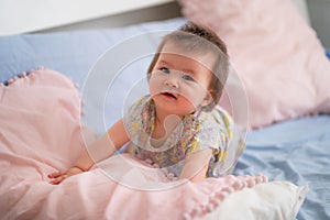 lifestyle home portrait of happy and adorable 9 months old mixed ethnicity Asian Caucasian baby girl playing cheerful and carefree