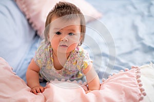 lifestyle home portrait of happy and adorable 9 months old mixed ethnicity Asian Caucasian baby girl playing cheerful and carefree