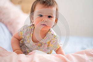 lifestyle home portrait of happy and adorable 9 months old mixed ethnicity Asian Caucasian baby girl playing cheerful and carefree