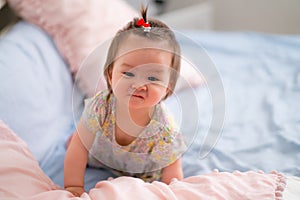 lifestyle home portrait of happy and adorable 9 months old mixed ethnicity Asian Caucasian baby girl playing cheerful and carefree