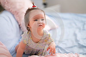 lifestyle home portrait of happy and adorable 9 months old mixed ethnicity Asian Caucasian baby girl playing cheerful and carefree