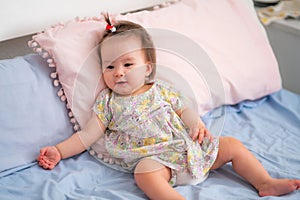 lifestyle home portrait of happy and adorable 9 months old mixed ethnicity Asian Caucasian baby girl playing cheerful and carefree