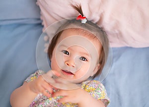 lifestyle home portrait of happy and adorable 9 months old mixed ethnicity Asian Caucasian baby girl playing cheerful and carefree