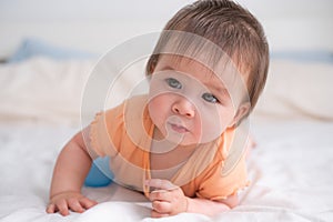 lifestyle home portrait of happy and beautiful 8 months old baby girl mixed race Asian Caucasian playing cheerful on bed exploring
