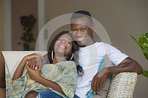 Lifestyle home portrait of young happy and successful romantic afro American couple in love relaxed sitting comfortable together