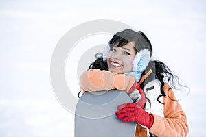 Lifestyle image of young adult snowboarder
