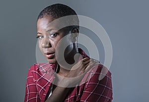 Lifestyle isolated portrait of young attractive and sad black african American woman feeling unwell and depressed and suffering pa