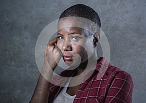 Lifestyle isolated portrait of young attractive and sad black african American woman feeling unwell and depressed and suffering pa