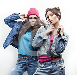 Lifestyle and people concept: Fashion portrait of two stylish girls best friends, over white background. Happy time