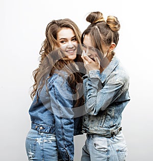 Lifestyle and people concept: Fashion portrait of two stylish girls best friends, over white background. Happy time