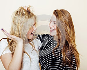 Lifestyle and people concept: Fashion portrait of two stylish girls best friends, over white background. Happy time