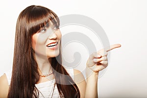 Lifestyle and people concept: happy woman poiting finger up on a