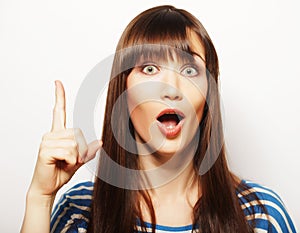 Lifestyle and people concept: happy woman poiting finger up on a