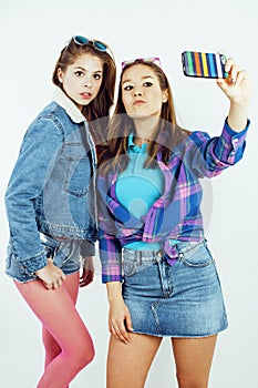 Lifestyle people concept: two pretty stylish modern hipster teen girl having fun together, happy smiling making selfie