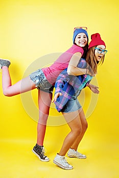 Lifestyle people concept: two pretty stylish modern hipster teen girl having fun together, happy smiling making selfie