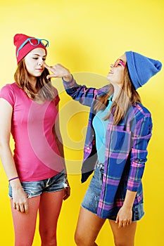 Lifestyle people concept: two pretty stylish modern hipster teen girl having fun together, happy smiling making selfie