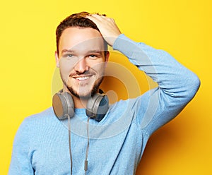 Lifestyle and people concept: young man listening to music with