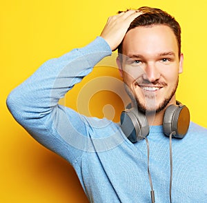 lifestyle and people concept: young man listening to music with
