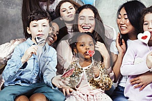 Lifestyle and people concept: young pretty diversity nations woman with different age children celebrating on birth day