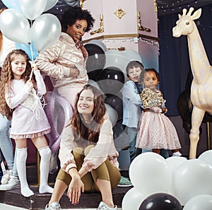 Lifestyle and people concept: young pretty diversity nations woman with different age children celebrating on birth day