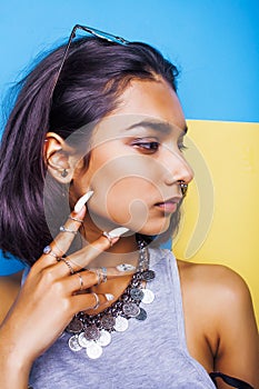 Lifestyle people concept. young pretty smiling indian girl with long nails wearing lot of jewelry rings, asian summer