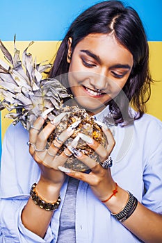 Lifestyle people concept. young pretty smiling indian girl with pineapple, asian summer fruits