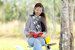 Lifestyle people girl reading book and drinking coffee for education outdoor garden at home.