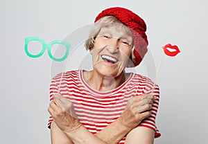 Lifestyle, people and party concept: funny grandmother wearing red clothes  ready for party