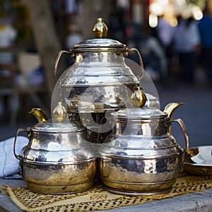 lifestyle photo iran stack of copper kettles outside shop