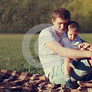 Lifestyle photo lovely father and son together resting outdoors