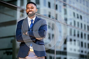 Lifestyle portrait of an african american business executive in a trendy suit and tie, cheerful, successful, proud, smiling near b