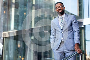 Lifestyle portrait of an african american businessman, charming, friendly, successful, stylish, fun, unique personality, next to f