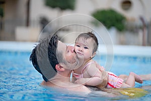 lifestyle portrait of father and little daughter enjoying summer - man holding her sweet baby girl excited and cheerful playing