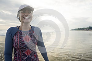 Lifestyle portrait of fit and happy middle aged woman after beach running workout - 40s or 50s attractive mature lady with grey