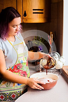 Lifestyle portrait of happy young woman cooking turkey and vegetables for Thanksgiving Dinner