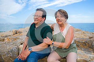 Lifestyle portrait of loving happy and sweet mature couple - senior retired husband and wife on 70s enjoying beach walk relaxed