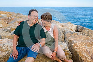 Lifestyle portrait of loving happy and sweet mature couple - senior retired husband and wife on 70s enjoying beach walk relaxed