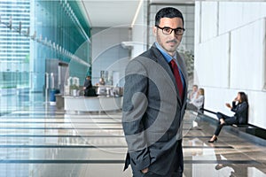 Lifestyle portrait of modern executive professional businessman attorney lawyer in business office elegant style confident