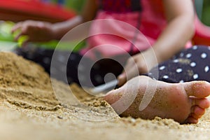 Lifestyle portrait mom son and daughter  playing with sand, Funny Asian family in a public  playground