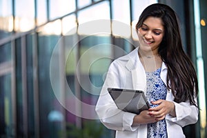 Lifestyle portrait of a professional medical psychiatrist, dental hygienist, pediatrician, doctor in white coat at hospital office