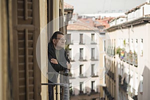 Lifestyle portrait of sad and depressed mature man 65 to 70 years old at home balcony feeling lonely and confused facing getting