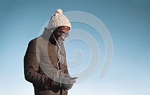 Lifestyle portrait of young african man enjoying listening music