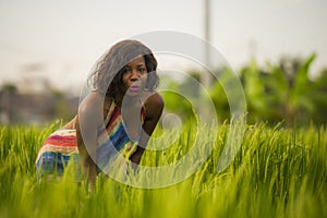 Lifestyle portrait of young attractive and happy black African American woman posing cheerful having fun outdoors at beautiful