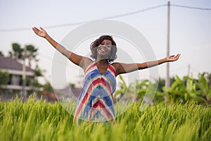 Lifestyle portrait of young attractive and happy black afro American woman posing cheerful having fun outdoors at beautiful rice