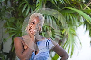 Lifestyle portrait of young attractive and joyful black african american woman smiling happy posing cheerful at home terrace with