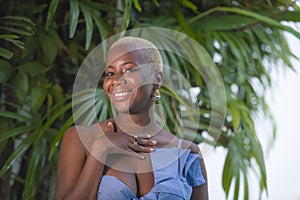 Lifestyle portrait of young attractive and joyful black afro american woman smiling happy posing cheerful at home terrace with gre