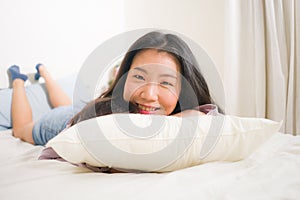 Lifestyle portrait of young and beautiful Asian woman at home -  attractive and happy Korean girl gesturing playful and cheerful